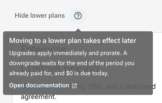 The Show lower plans control expanded, with a help tooltip explaining that a downgrade takes effect at the end of the paid period