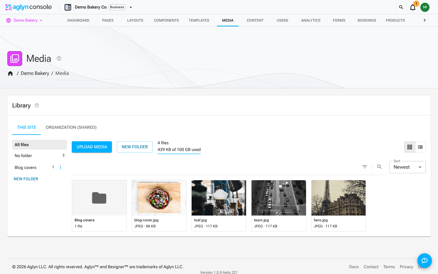 The Media page in the Aglyn console: the site library in the Grid view, with its folder rail, the Filters and Search toolbar beside the Sort control, a folder card and thumbnails